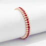Guldfärgat armband Spike Noir, röda stenar med nitar - Elastiskt