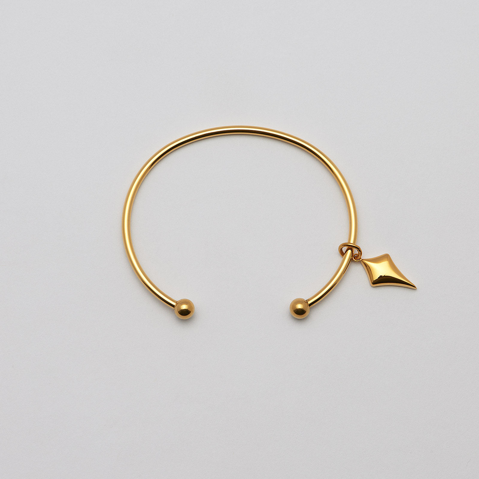 Armband i guldpläterat stål, bangle pil- 66,5 mm